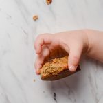 toddler holding healthy oatmeal cookie