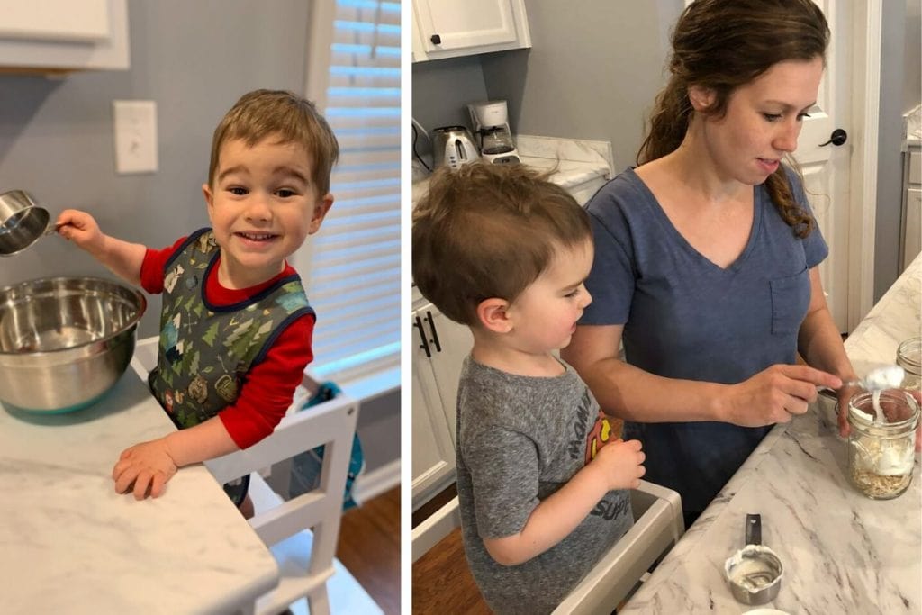 toddler standing in a learning tower helping mom in kitchen