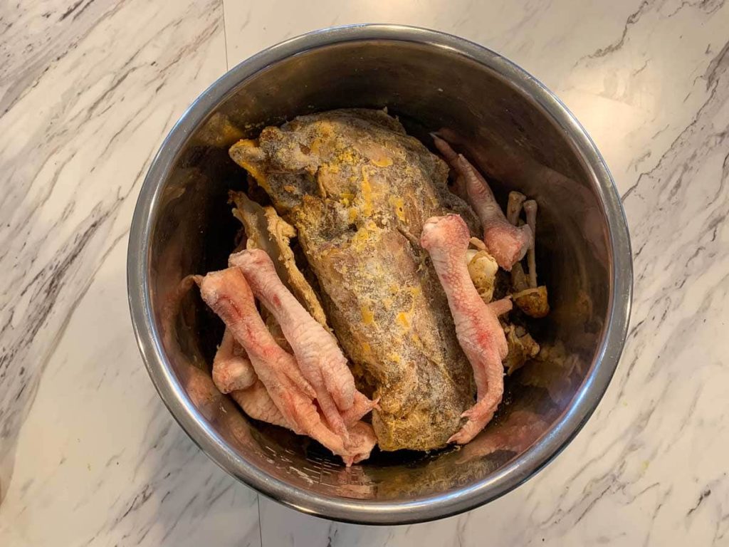 chicken feet and bones with water for bone broth
