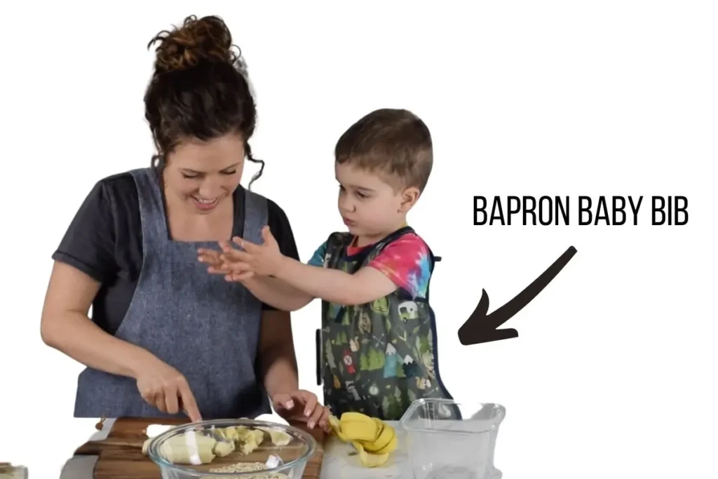 toddler cooking in a bapron baby bib